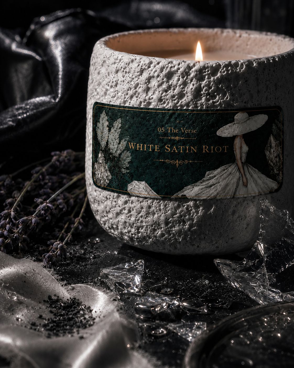 Close-up of the White Satin Riot stone candle with its gowned-figure label and lavender