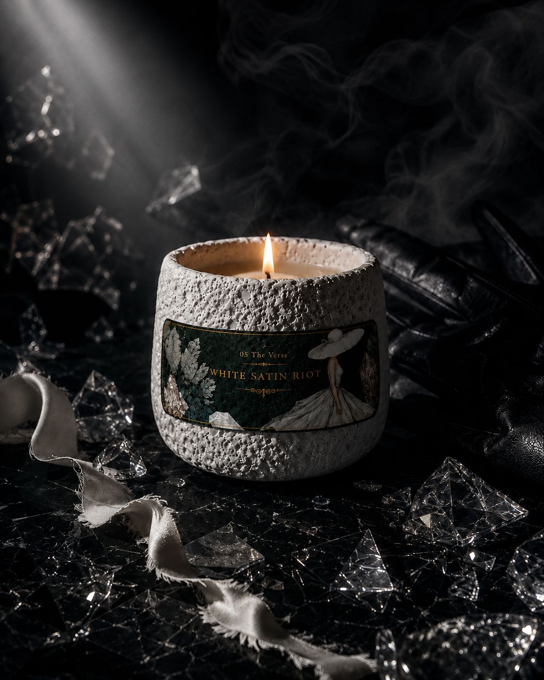 White Satin Riot textured white-stone candle lit among shattered glass and white satin — Ironic Paradoxists